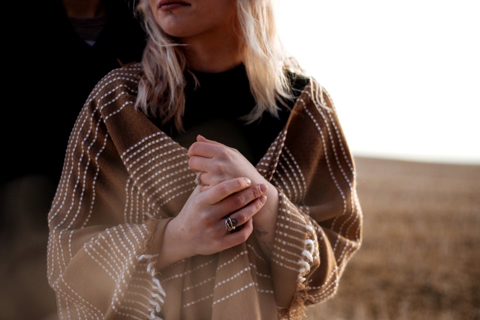 woman covered in brown scarf with cross hands photo