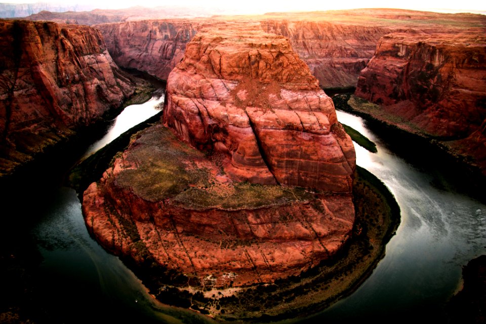 brown rocky mountain and body of water at daytime