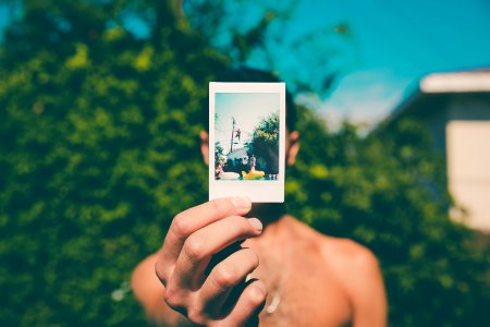topless man holding photo of person diving on pool selective focus photography photo