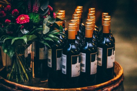 black glass bottles on round table with flowers photo