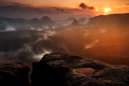photograph of mountains surrounded by mist photo