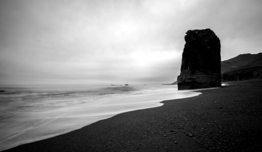 large rock on shore grayscale photography photo