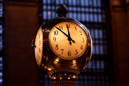 turned on brass-colored train station analog clock photo