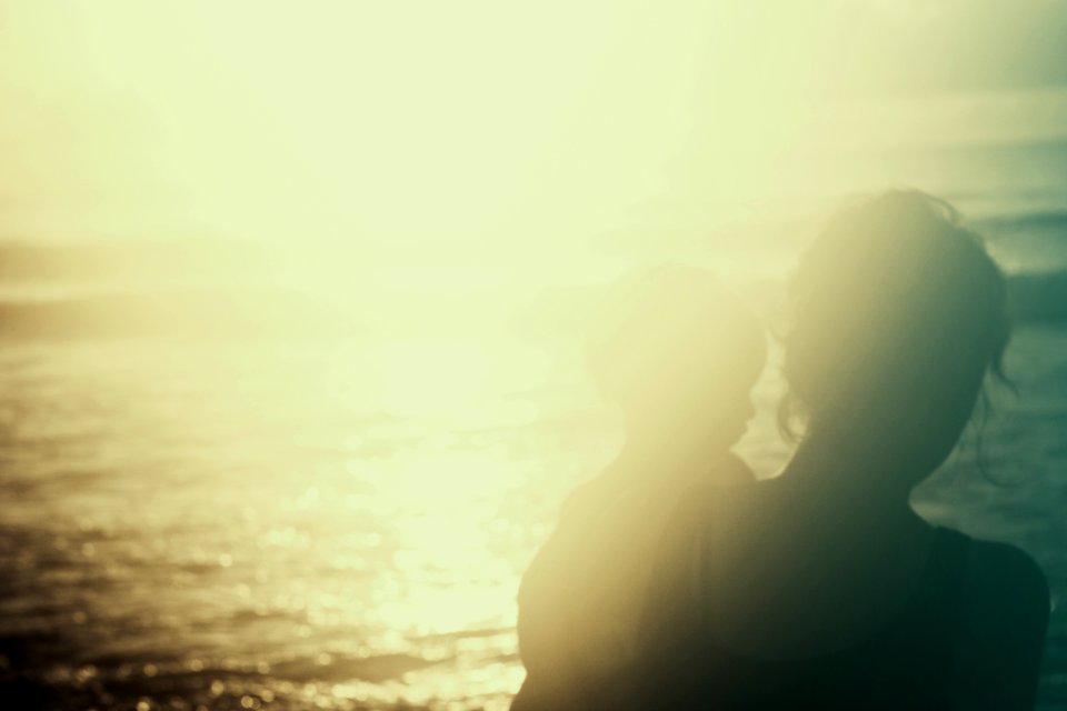 silhouette photography of person carrying a child