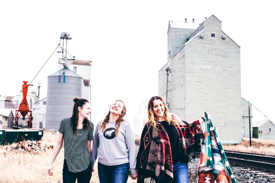 three women walking from industrial location