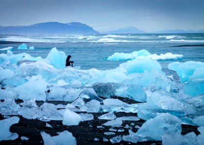 man standing in middle of ice burg photo