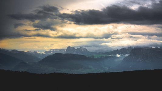 silhouette of mountains under cloudy sky photo