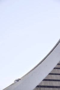 A cable car on a concrete structure with a curving slope photo