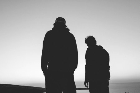 silhouette of two man photo
