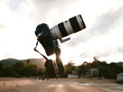 surrealism photo of white and black DSLR camera during golden hour photo
