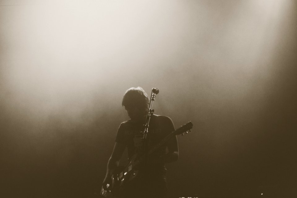 man playing electric guitar on stage photo