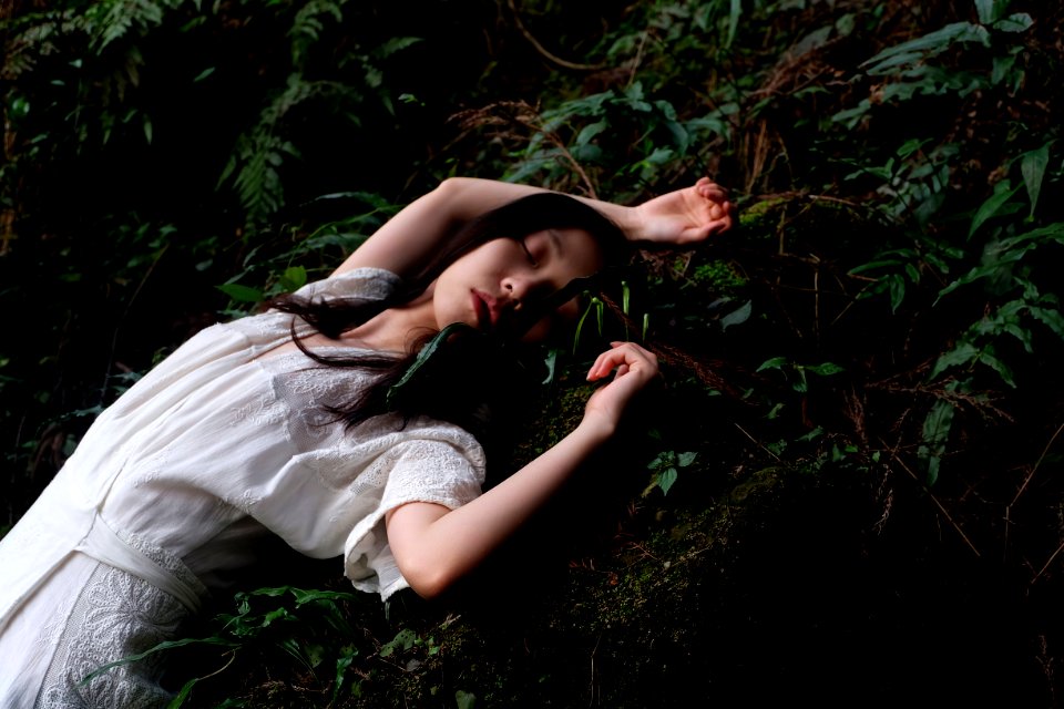 woman in white dress lying in white dress