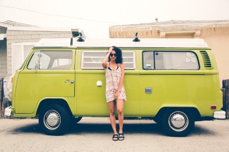 woman leaning on green bus photo