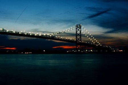 gray steel bridge during night time photo