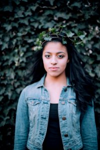 woman standing front of vine plant photo