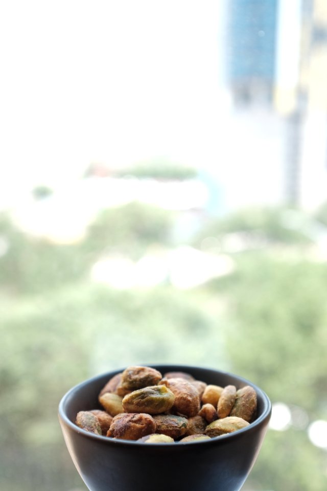 selective focus photography of nuts on black ceramic bowl