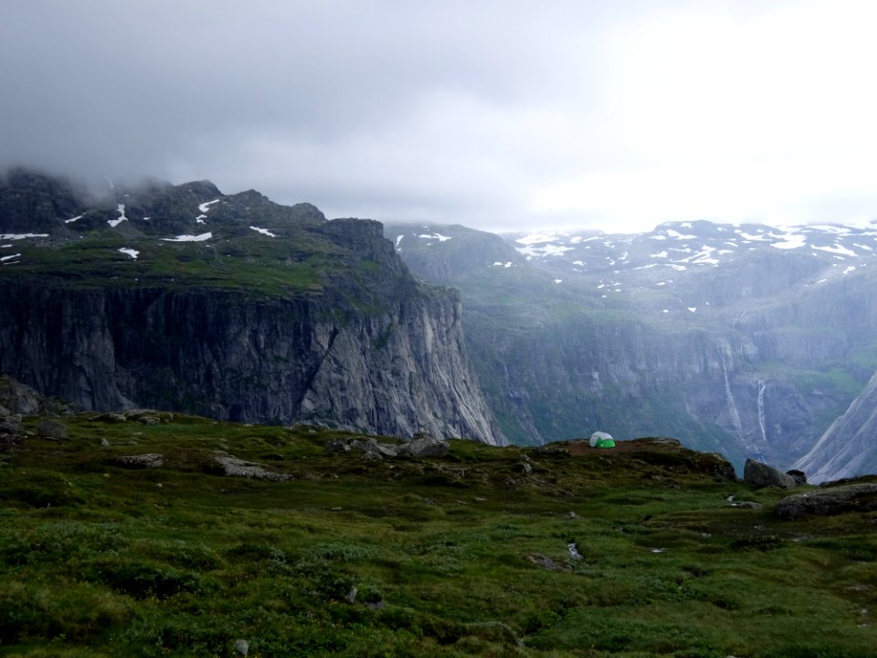 mountain range with grass and snow
