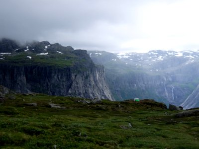 mountain range with grass and snow