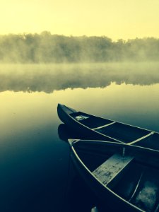 two gray canoes on misty body of water photo
