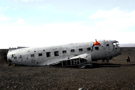 person doing back flip on wrecked plane photo