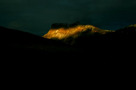 brown rock formations under nimbus clouds photo