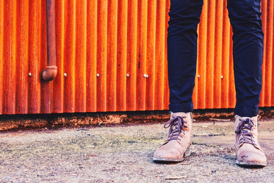 person standing in front orange galvanized iron sheet panel