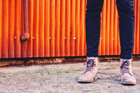 person standing in front orange galvanized iron sheet panel