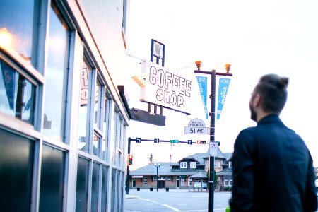 man in front of coffee shop store photo