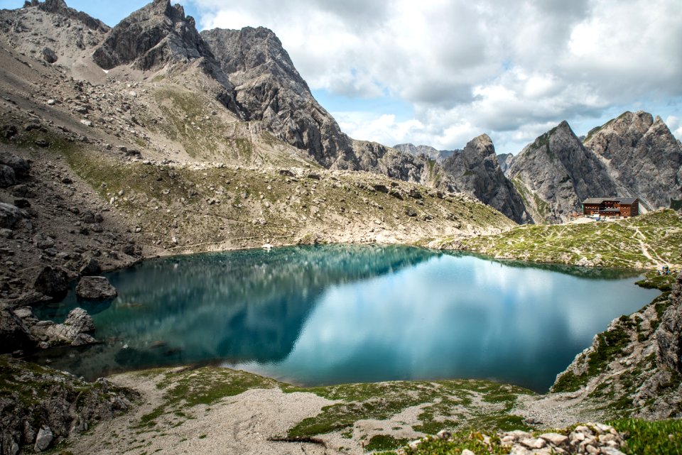 landscape photography of lake surrounded with mountains