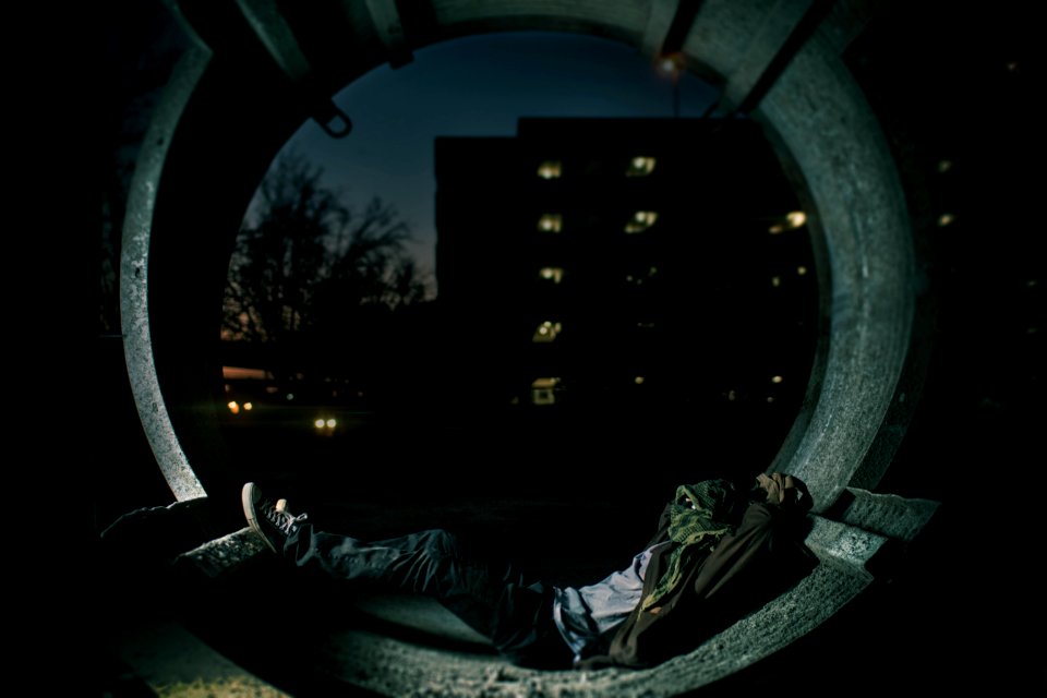 person laying inside hallway with building as background photo