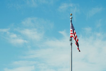 flag of America on pole with clouds photo
