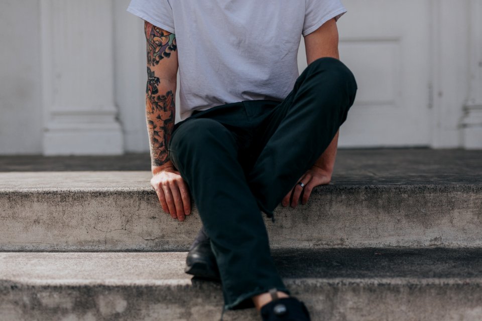 person sitting on gray concrete flooring photo