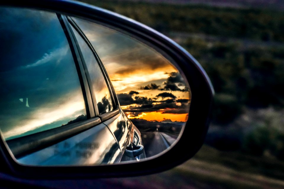 side mirror showing dark sky