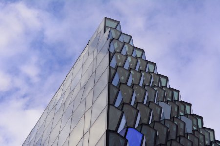 low angle photography of glass building under cloudy sky at daytime photo