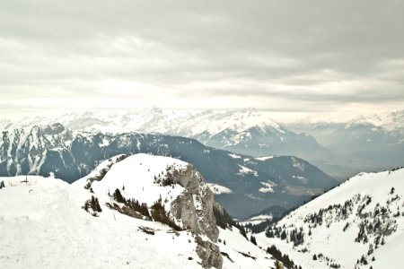 mountain cover with snow under grey sky photo