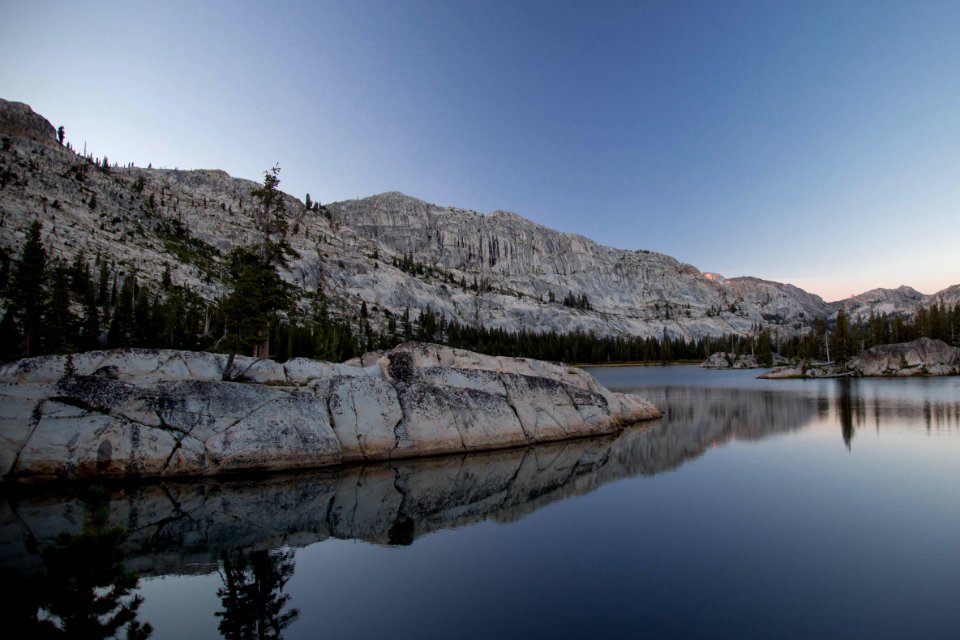 white mountain near body of water