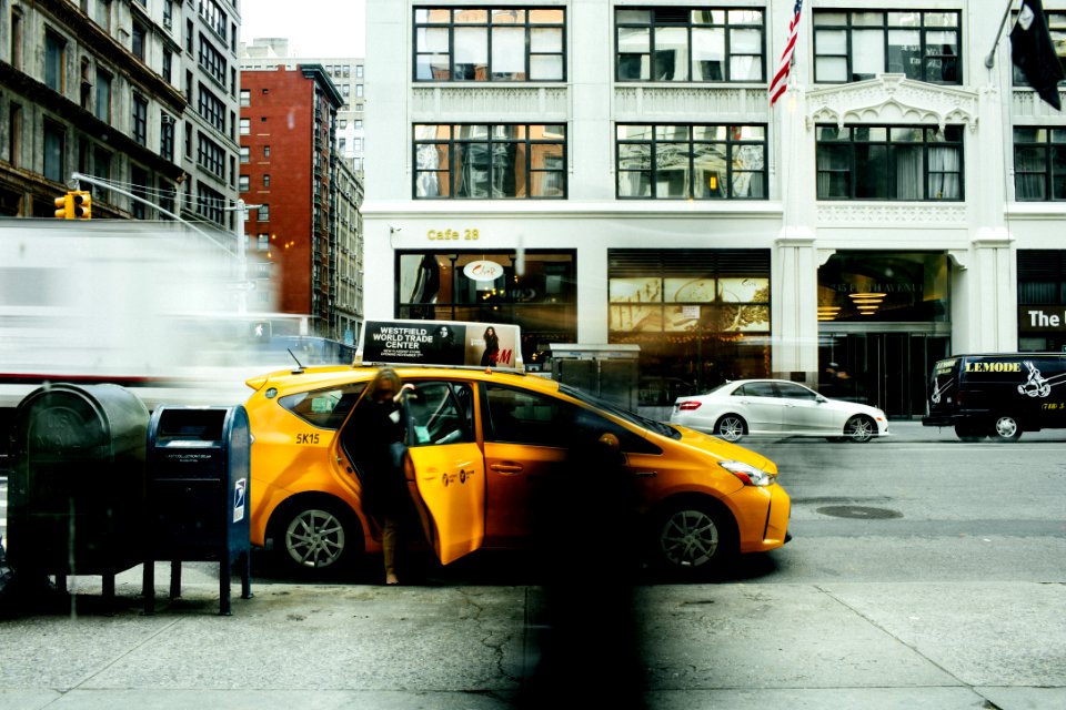 woman going inside yellow car