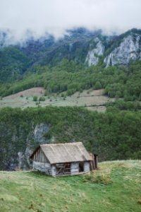 gray wooden house on mountain photo