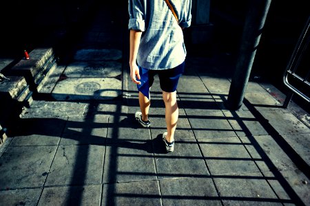 person standing on gray pavement during daytime photo