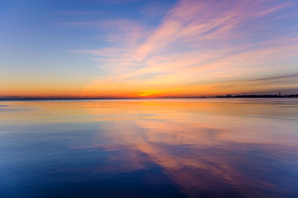 body of water under cloudy sky