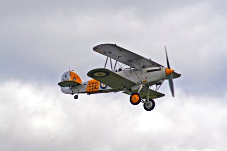 white and orange bi-plane in mid air photo