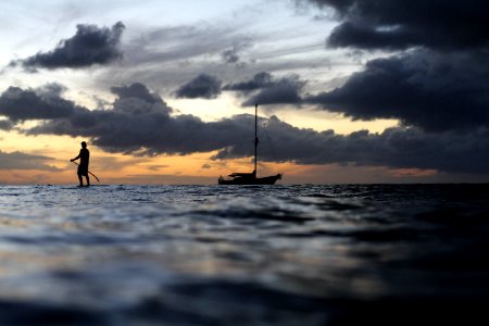 silhouette photo of boat during daytime photo