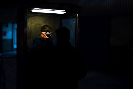 man holding a camera taking a photo of a man in front of him photo