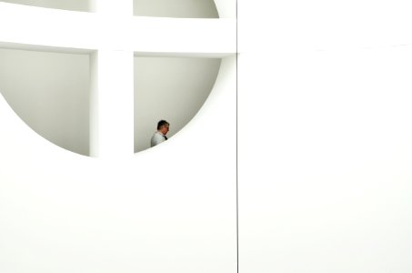 man near white window