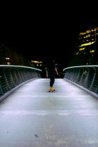 man skating on gray concrete road photo