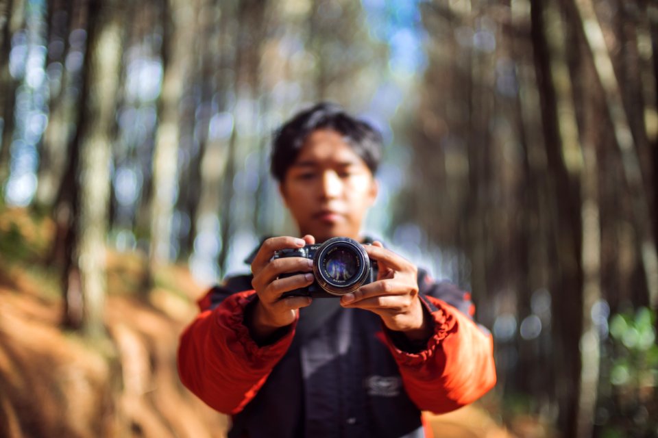 man holding camera taking a photo