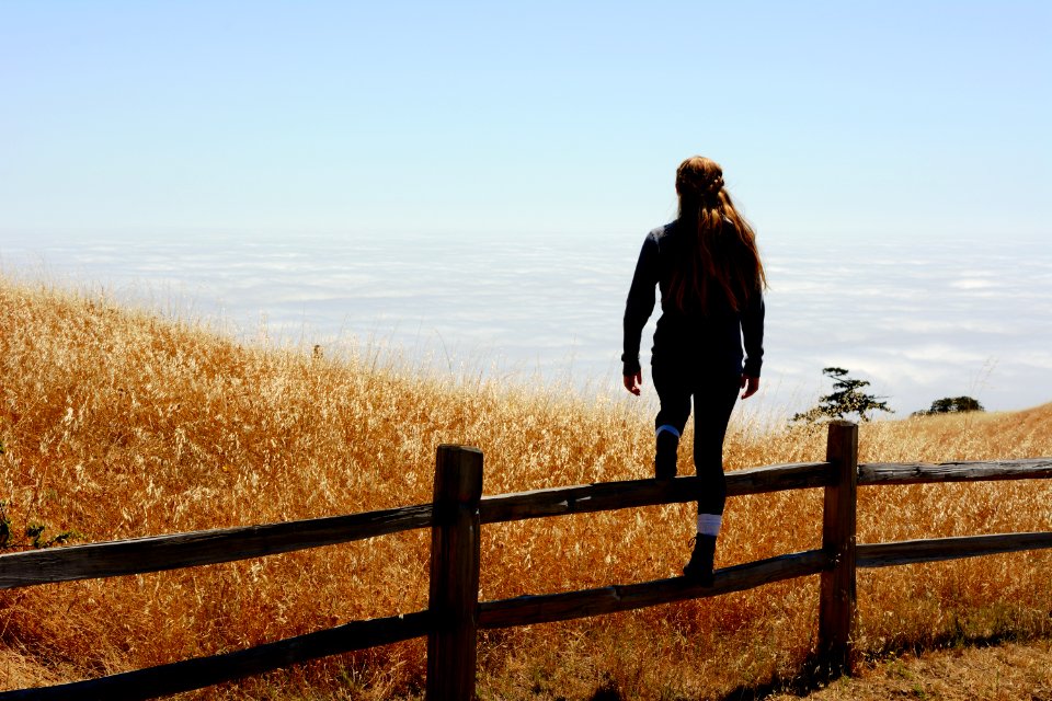 woman jump on brown fence