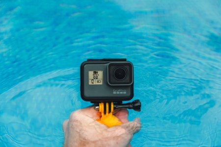 person holding GoPro HERO photo