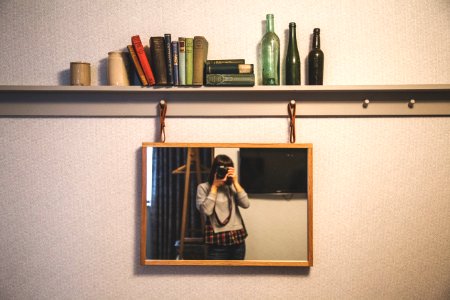 woman taking photography in front of the mirror photo