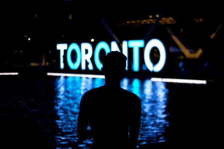 man facing Toronto LED signage